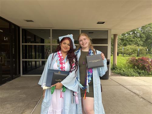 students posing with diploma